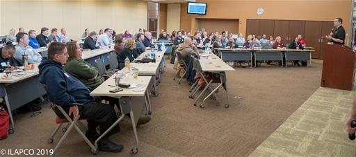 Symposium Attendees Listen to Speaker